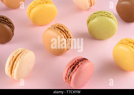 Macarons on pastel background. Classic french macaroons with different tastes. Stock Photo