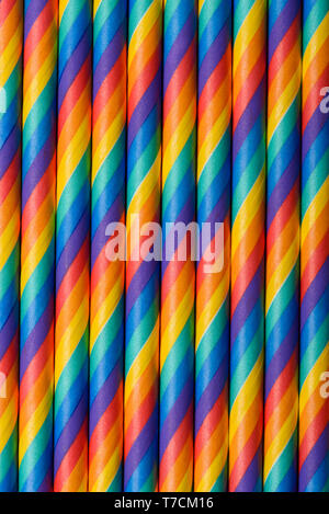 Rainbow multicolored striped paper straws vertical background Stock Photo