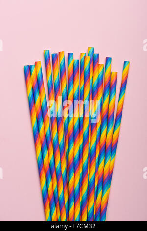 Bouquet of rainbow paper straws on pastel background Stock Photo