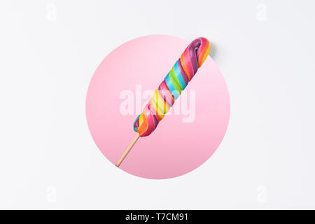 Lollipops candy on stick big colorful rainbow in a layered paper design with circle cut pink background copy space Stock Photo