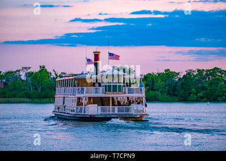 Orlando, Florida. April 23, 2019. Disney Ferry boat in blue lake on colorful sunset background at Walt Disney World  (2) Stock Photo