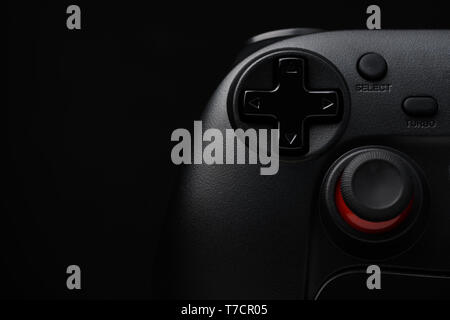 Dark game pad video game controller joy stick on black background with copy space Stock Photo