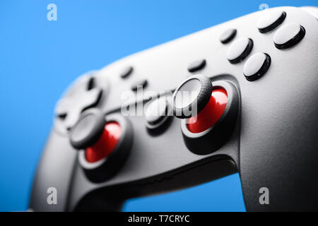 Game pad. Video game controller joy stick on blue background. Stock Photo