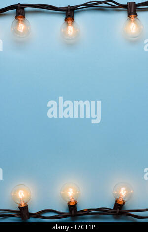 Light bulbs retro garland string lights on blue background Stock Photo