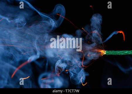 Fuse burning with sparkles and smoke on black background. Dynamite petard  firecracker green fuse Stock Photo - Alamy