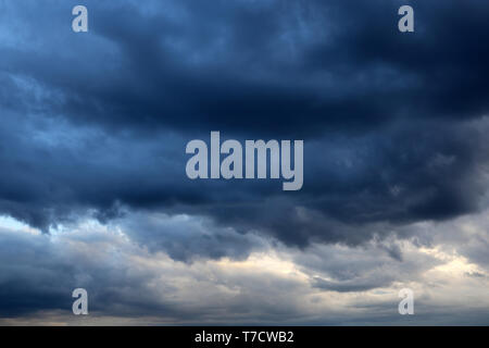 Storm sky covered with dark cumulus clouds before the rain. Dark cloudy sky, overcast day, beautiful dramatic background for stormy weather Stock Photo