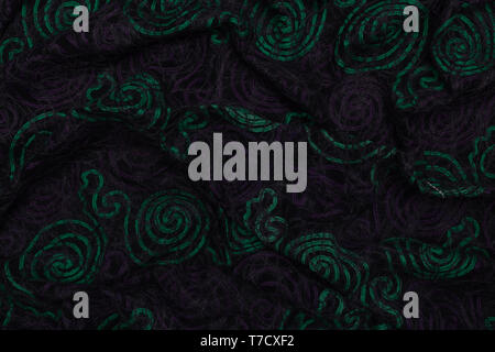 Creative dark fabric with green and violet patterns with textile texture background Stock Photo