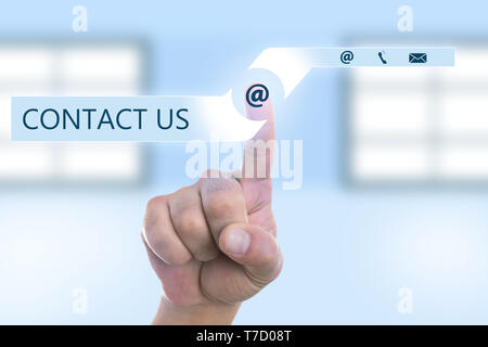 Person pressing email symbol with index finger on invisible screen closeup as contact us concept Stock Photo