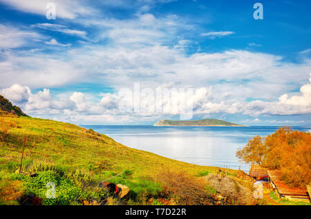 Beautiful calm sea, meadow field, clouds, sky and island landscape of a holiday place in Cukurbuk bay, Bodrum, Mugla, Turkey Stock Photo
