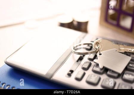 Calculator on Notepad, Key with Trinkel Desktop Stock Photo