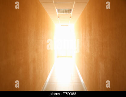 Long narrow tunnel with light in the end Stock Photo