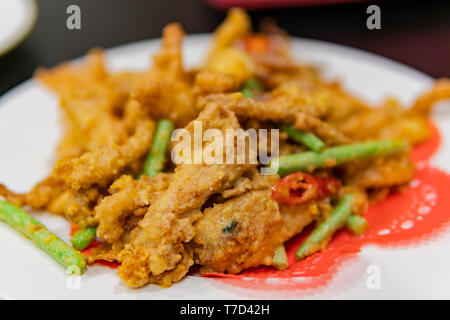 Close up shot of a dish of deep fried pork meat with salted duck egg and vegetable, ate at Taipei, Taiwan Stock Photo