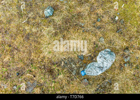 Plastic water bottle left on forest floor in a remote location Stock Photo