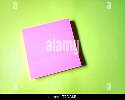 Blank pink stick note isolated on yellow background Stock Photo