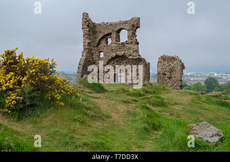 Saint Anthony's Chapel Ruins at Holyrood Park with view across Edinburgh, Scotland behind. Stock Photo