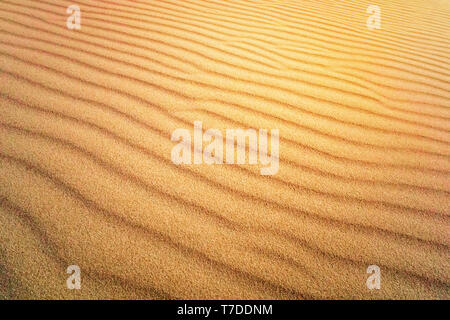 Sand Texture. Background from fine sand. Sand background. yellow dune in the sun. The sun shines on sand. Stock Photo