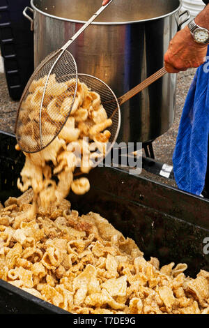 When it comes to street food, fresh made pork skins are a great treat. Stock Photo