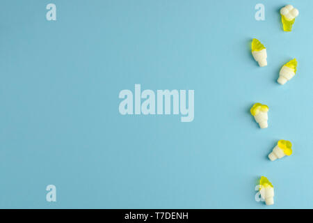 Gummy jellies in a row on pastel blue background. Ice cream shape. Copy space Stock Photo