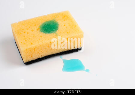 Yellow soapy sponge with detergent on white background. Copy space. Stock Photo