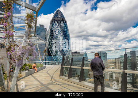 The Gherkin from The Garden at 120 , a roof garden in the City of London on the roof of Fen Court office building , London, UK Stock Photo