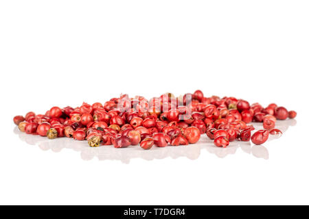 Lot of whole peruvian pink pepper heap isolated on white background Stock Photo