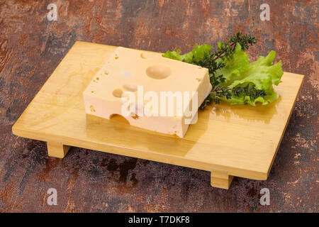 Maasdam cheese brick with thyme branch Stock Photo