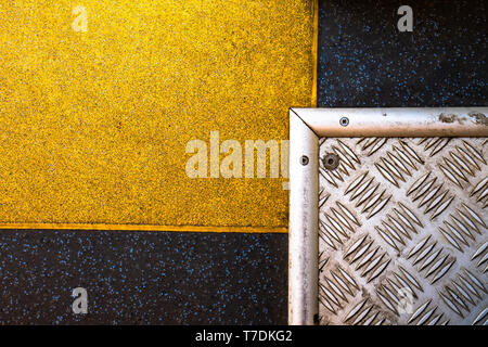 A silver steel plate that crosses a yellow plate on a graphite background. Intersecting plates form rectangles. Great abstract shapes. The perfect tex Stock Photo