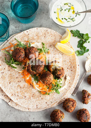 Falafel Wraps with hummus and tzatziki Stock Photo