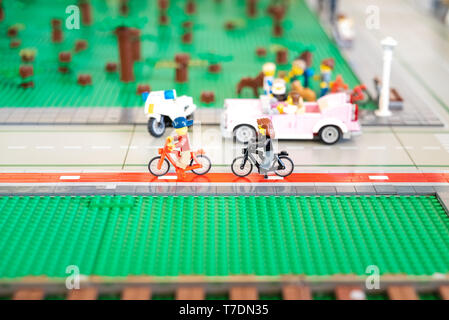 Valencia, Spain - April 3, 2019: Two Lego figures of urban cyclists walking through the city. Stock Photo