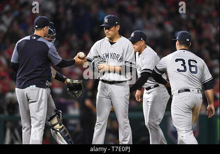 New York Yankees starting pitcher Masahiro Tanaka hands the ball to manager Aaron Boone as he is pulled in the sixth inning during the Major League Baseball game against the Los Angeles Angels at Angel Stadium in Anaheim, California, United States, April 25, 2019. Credit: AFLO/Alamy Live News Stock Photo