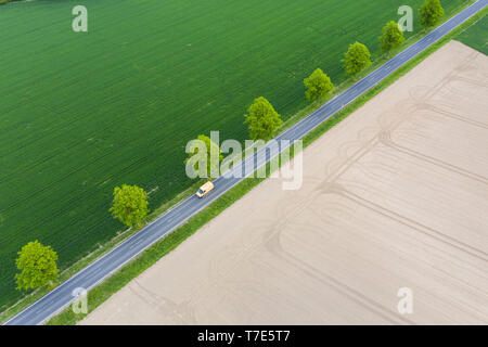 07 May 2019, Lower Saxony, Pattensen: A car drives on a country road. (Aerial photograph with drone) Photo: Christophe Gateau/dpa Stock Photo