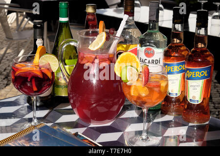 Selection of various alcohol Bacardi rum drinks beverages in bottles, jug and glasses with sliced lemon sitting on table in a Lisbon bar  KATHY DEWITT Stock Photo