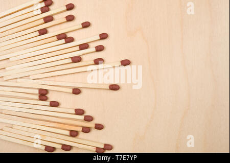 Matchsticks in a row on wooden table. Stock Photo