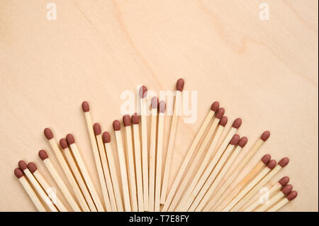 Matchsticks in a row on wooden table. Stock Photo