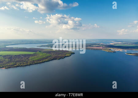 Scenic aerial panoramic landscape of Oskol river curve in eastern Europe with green forest at banks and blue cloudy sky. Natural scenic summer travel  Stock Photo