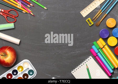 The concept of education. Back to school. Stationery on the background of black boards. Copy Space. Flat lay. Stock Photo