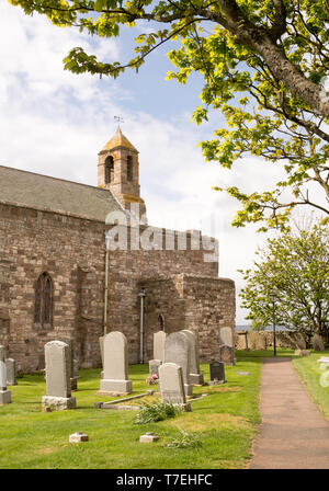 The graveyard of the Parish Church of Saint Mary the Virgin in Lindisfarne, Northumberland, England, UK Stock Photo