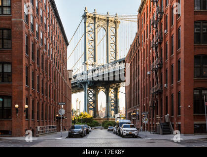 Brooklyn, NY historic DUMBO neighborhood street scene with view of Manhattan Bridge and Empire State Builiding Stock Photo