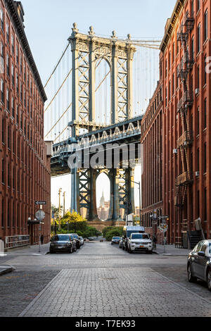 Brooklyn, NY historic DUMBO neighborhood street scene with view of Manhattan Bridge and Empire State Builiding Stock Photo