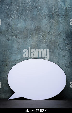 Speech Bubble lightbox on table. Plastic light box in form of chat message icon. Stock Photo
