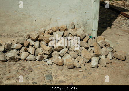 Pile of setts stones in a construction site next to a house at Castelo de Vide. Nice town with medieval castle at the Portugal eastern border. Stock Photo