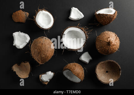 Flat lay composition with coconuts on black background Stock Photo