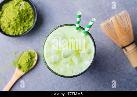 Matcha green tea ice latte with matcha powder and bamboo whisk. Top view. Stock Photo