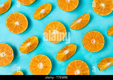 Oranges on blue background. Flat lay composition. Top view. Stock Photo