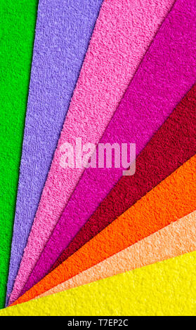 Multicolored background. Colored material for decoration spread out like a fan. Rough Stock Photo
