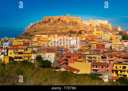 The picturesque town of Castelsardo with colourful houses, a bell tower and a fortified castle, surrounded by the Mediterranean Sea and glowing in the Stock Photo