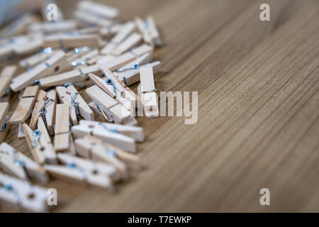 close up a lot of wooden new clips on the wood table. Stock Photo