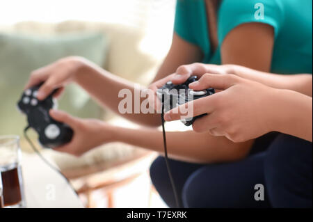 Teenagers playing video games at home Stock Photo