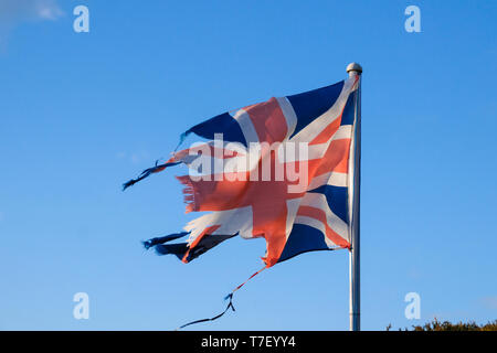 Torn and tattered Union Jack flag symbol of The UK. Stock Photo