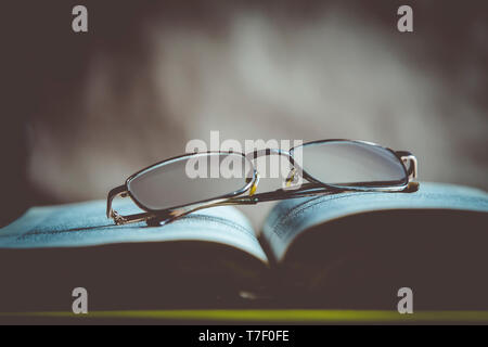 Back to school concept. Glasses on a book. Open book with glasses Stock Photo